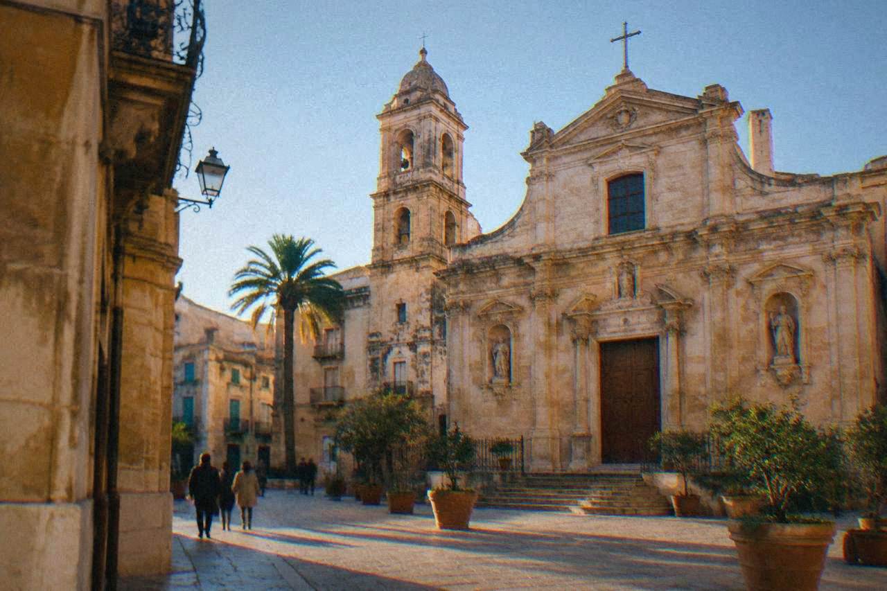 A historic Sicilian church facade in warm afternoon light