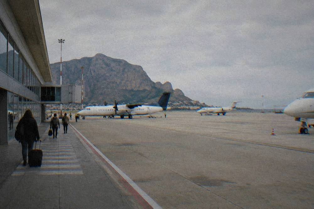 A small regional airport terminal in western Sicily with aircraft parked on the apron