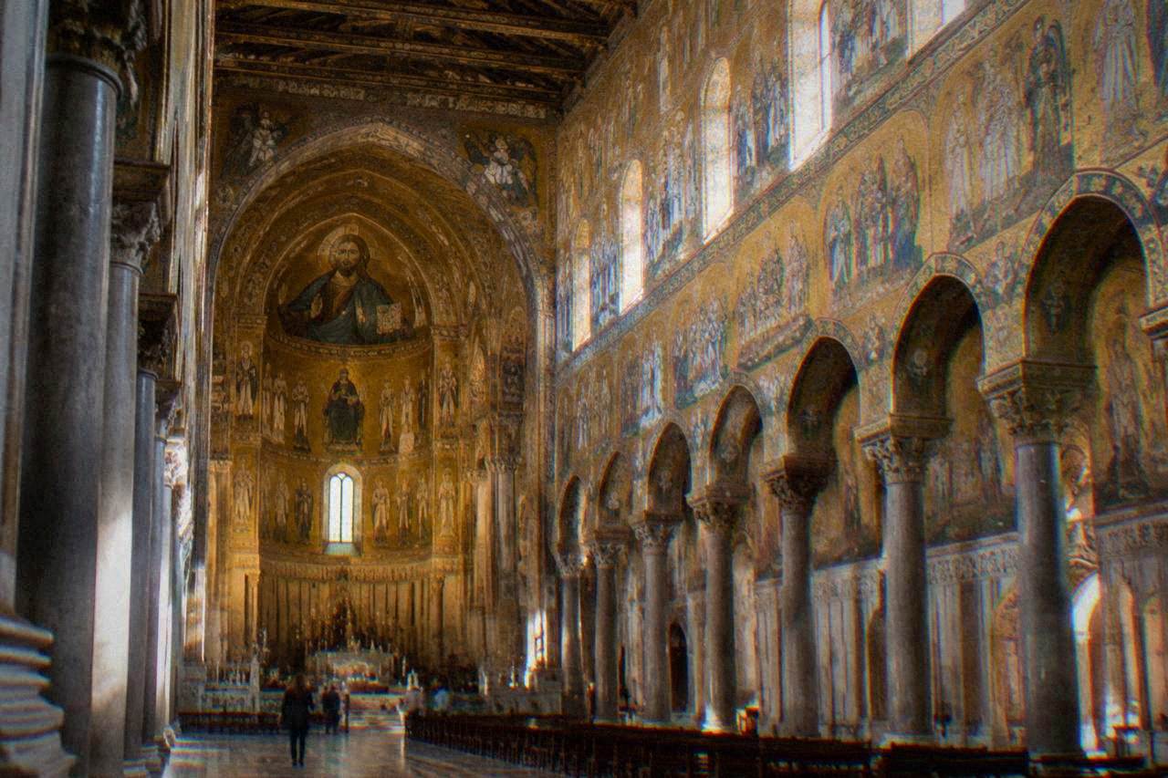 Interior of Monreale Cathedral with gold mosaic figures covering the walls above the nave