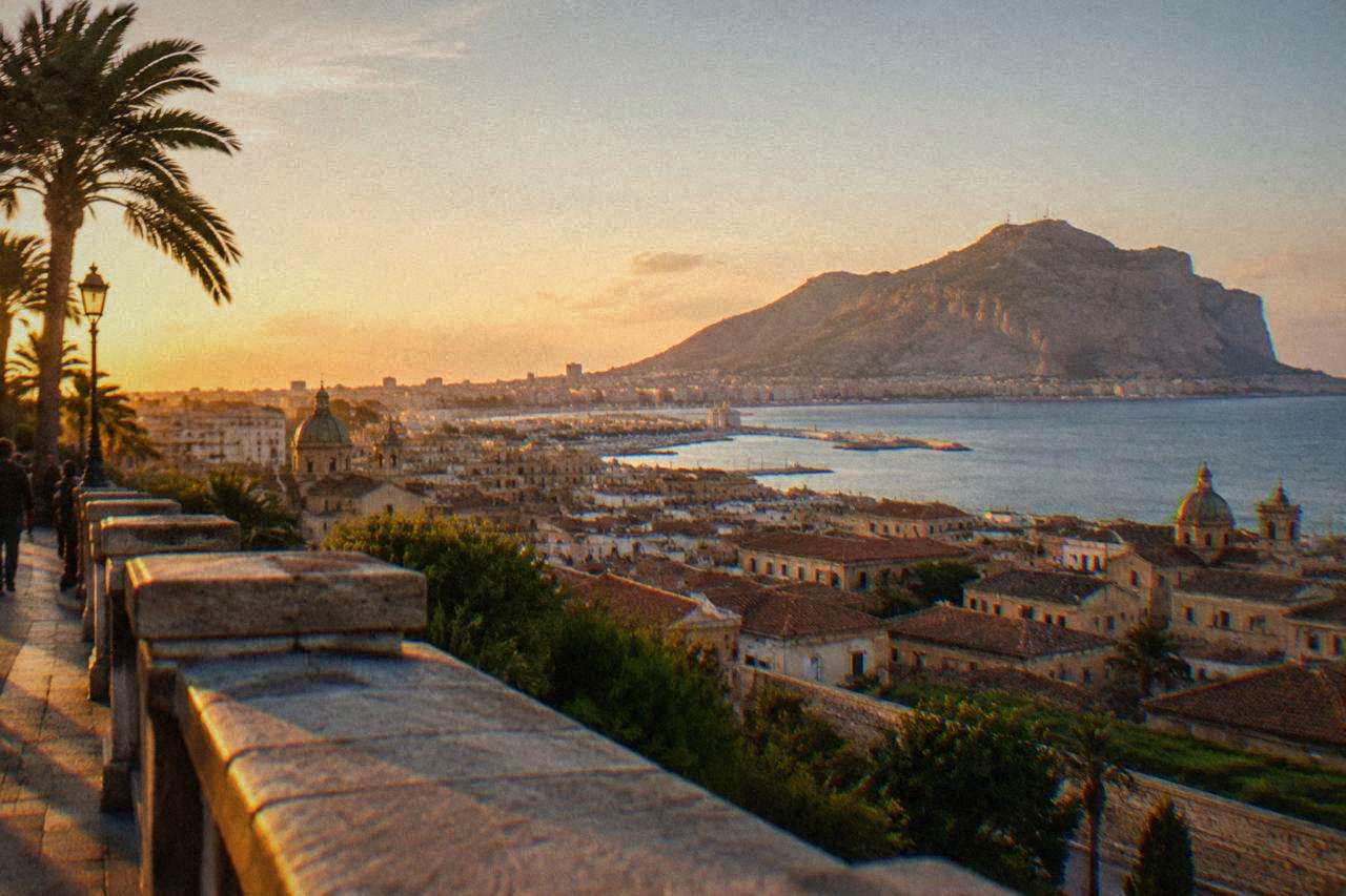 View over Palermo rooftops toward the Tyrrhenian Sea with Monte Pellegrino in the background