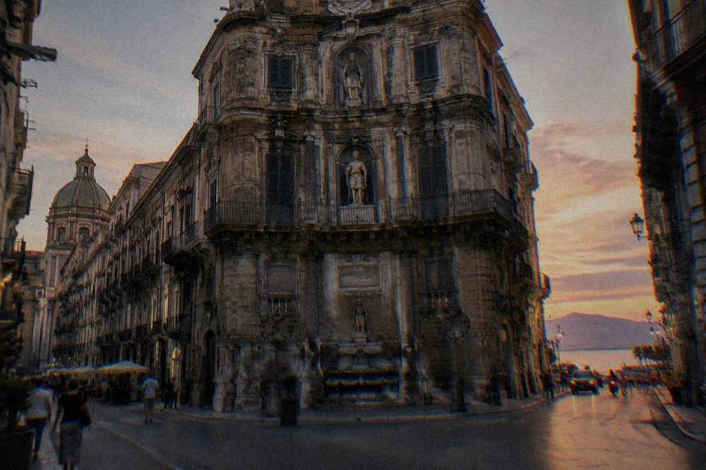 Ornate baroque facade at the Quattro Canti crossing in central Palermo in warm evening light