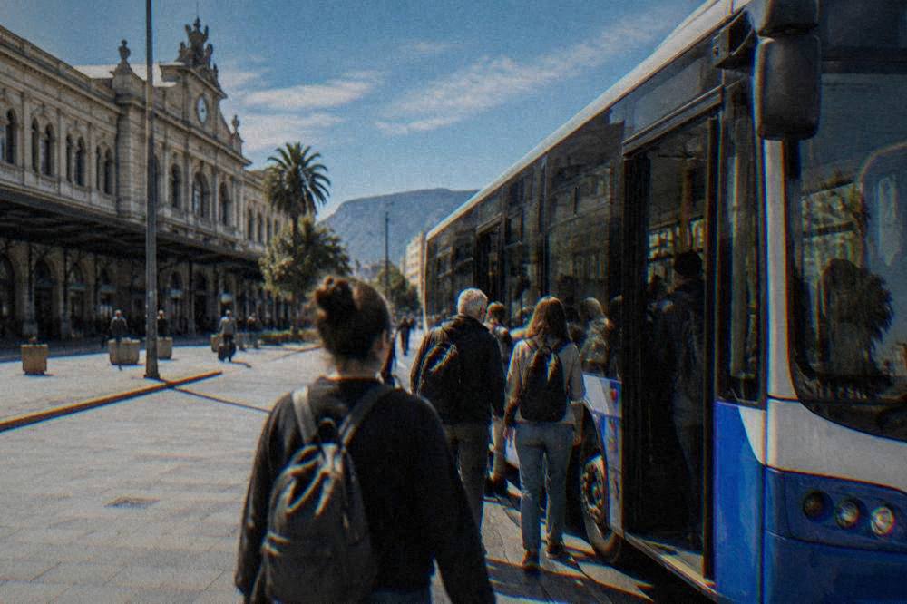 Passengers boarding a city bus outside Palermo Centrale railway station