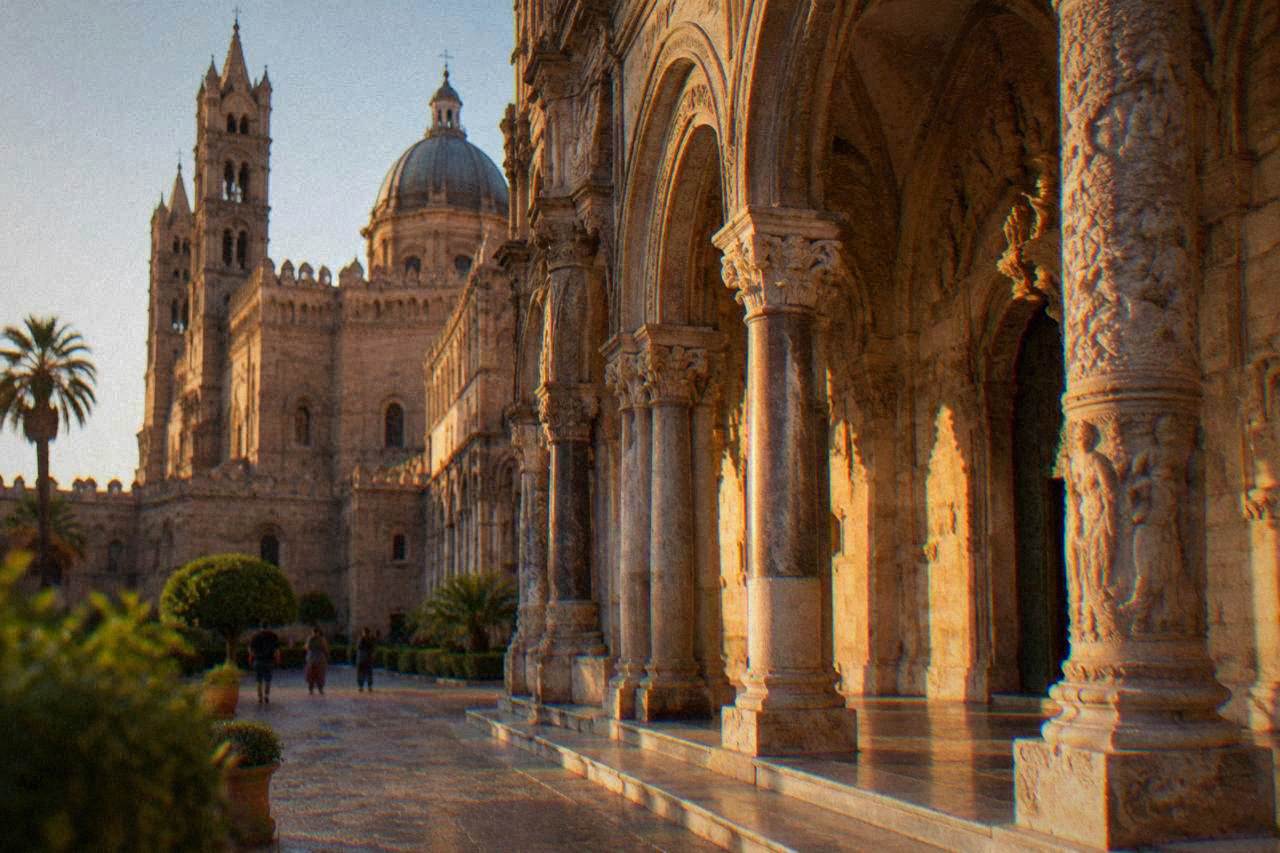 The southern porch of Palermo Cathedral with its carved columns and tall arched facade in warm stone