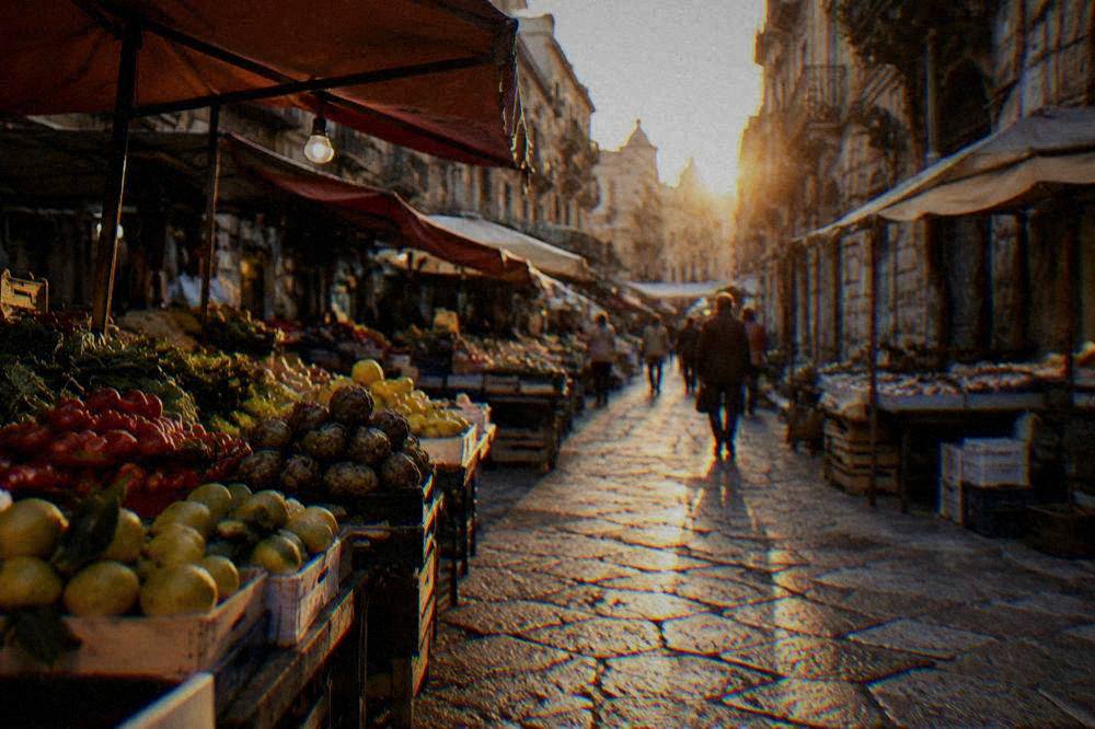 A pedestrian street in Palermo's historic centre lined with old buildings and market stalls