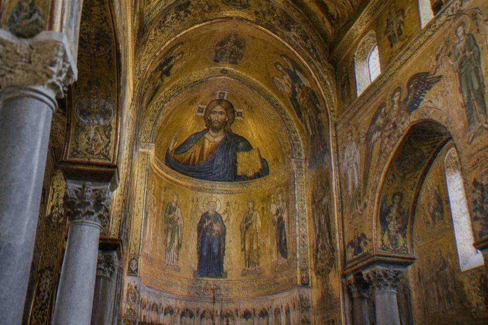 Golden mosaic interior of a Palermo chapel lit by soft daylight