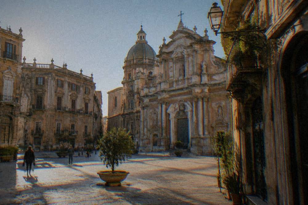 Sunlit square with baroque buildings in the Albergheria quarter of Palermo