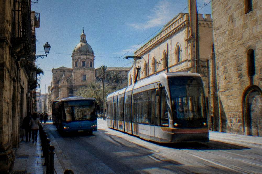 City bus and tram on a Palermo street near the historic centre