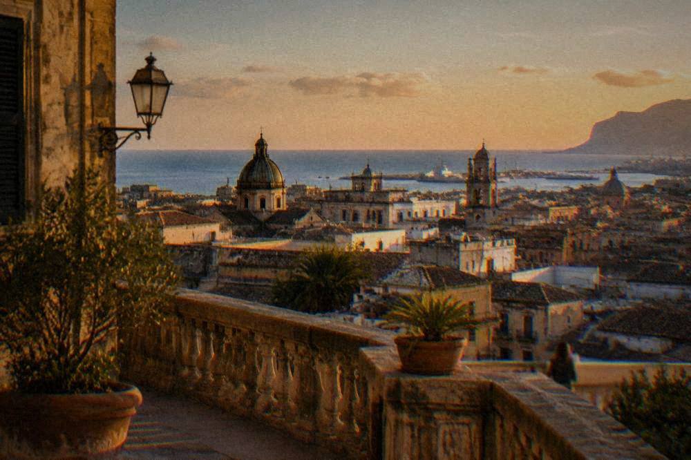 View from a palace terrace over the rooftops of Palermo toward the sea