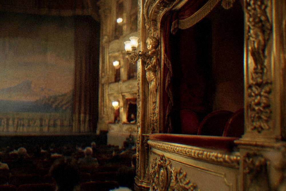 A gilded theatre box interior seen from the auditorium floor