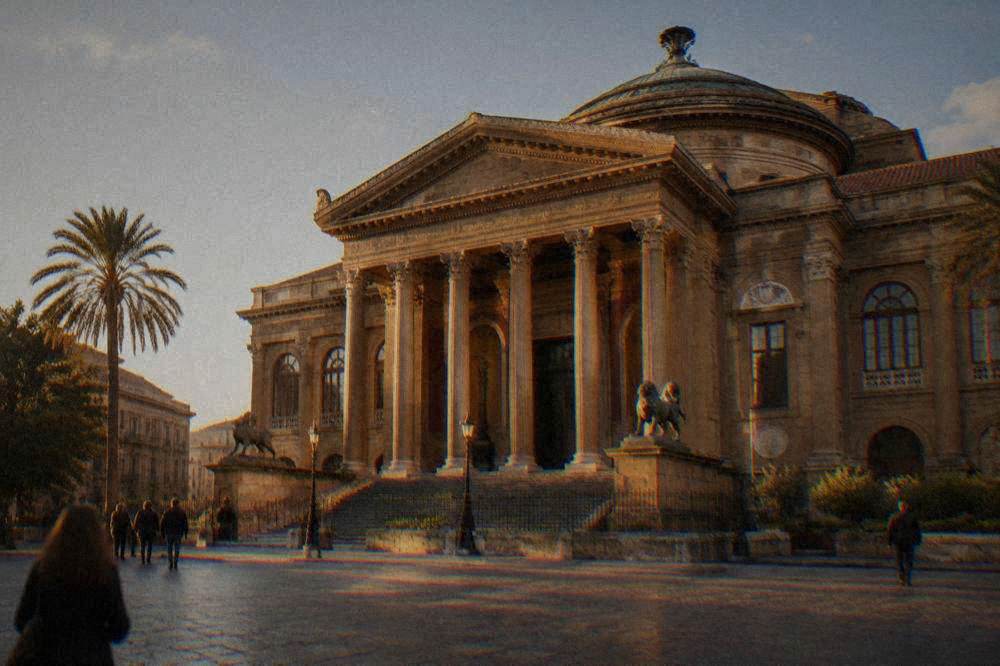 The neoclassical columned facade of Teatro Massimo in Palermo seen from the square