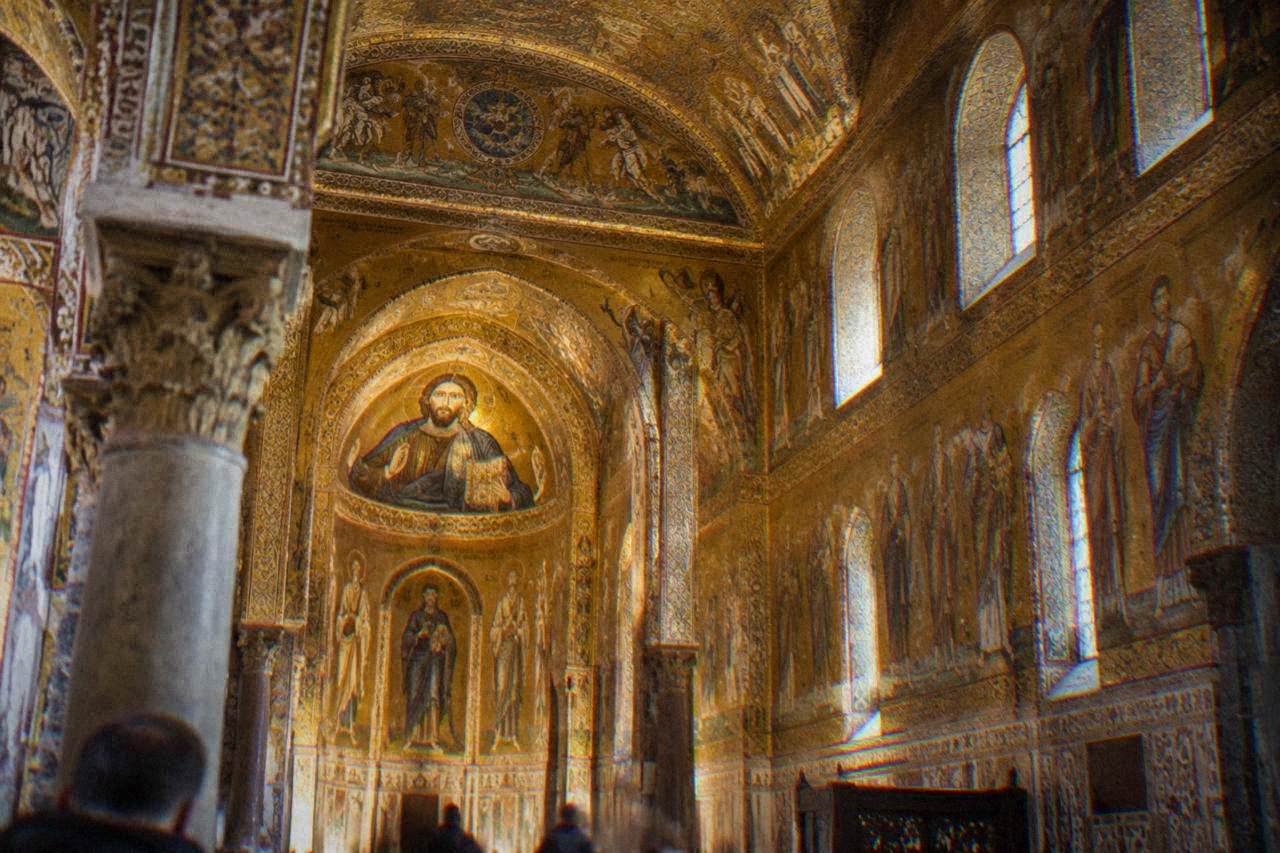 Interior of the Palatine Chapel in Palermo with gold mosaics covering the walls and ceiling