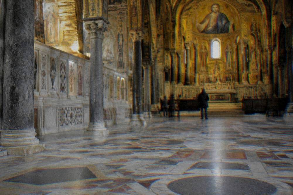 Sunlit stone pavement with geometric inlay inside the Palatine Chapel