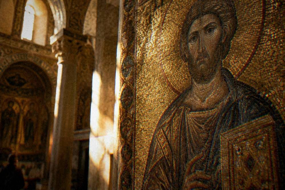 Detail of a gold mosaic depicting a religious figure against a shimmering background