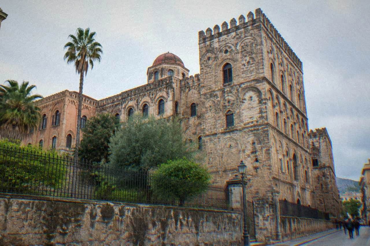 The fortified exterior of the Norman Palace in Palermo seen from the street below
