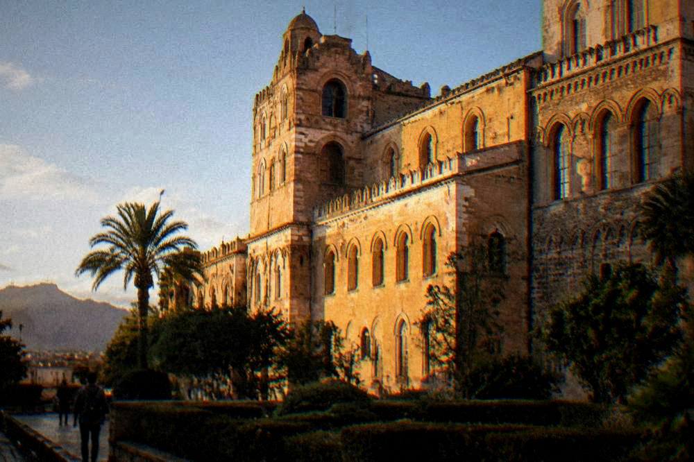 The facade of the Norman Palace in Palermo lit by late afternoon sun