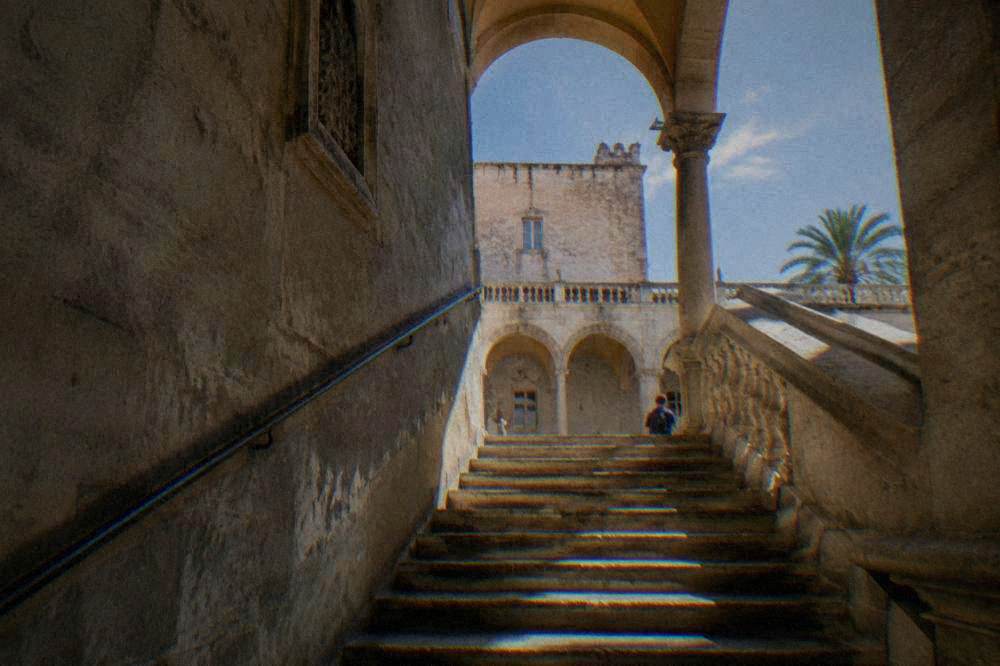 Sunlight falling on a stone staircase inside an old Palermo palazzo
