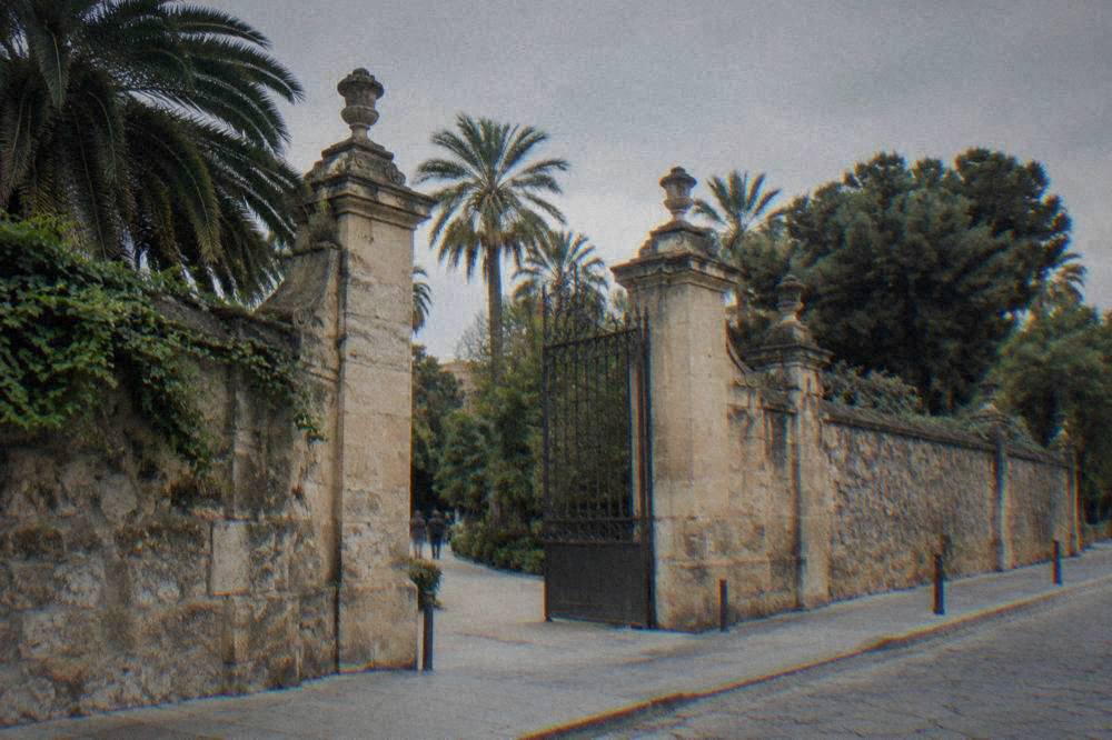 Entrance gate and stone wall of the Botanical Garden on Via Lincoln in Palermo