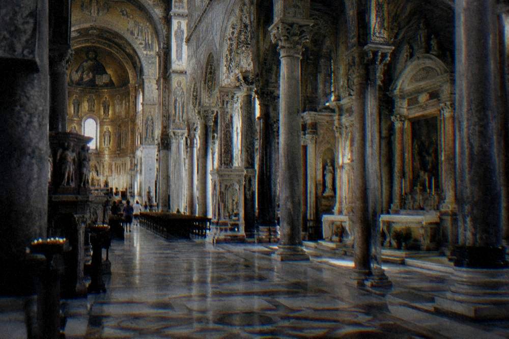The cathedral interior with its columns, arches and side chapels in soft light
