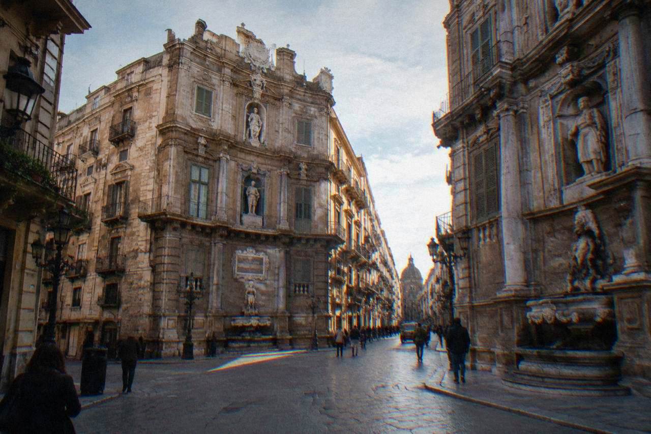 The four curved baroque facades of the Quattro Canti crossing in Palermo seen from street level