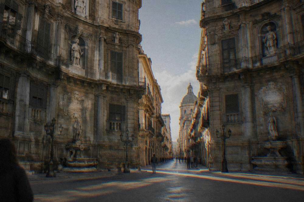 Street level view of two Quattro Canti facades facing each other across the crossing in Palermo