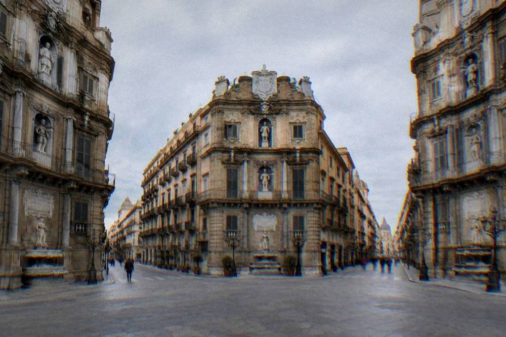 A wide view of the Quattro Canti crossing in Palermo showing all four corner facades