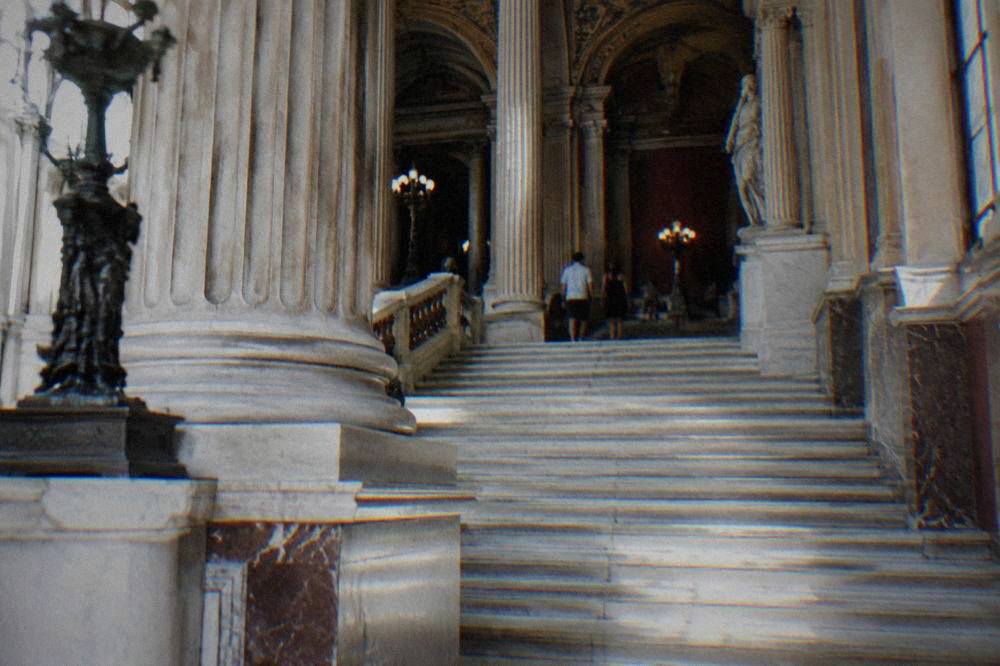 The grand staircase inside the Teatro Massimo with marble steps and columns