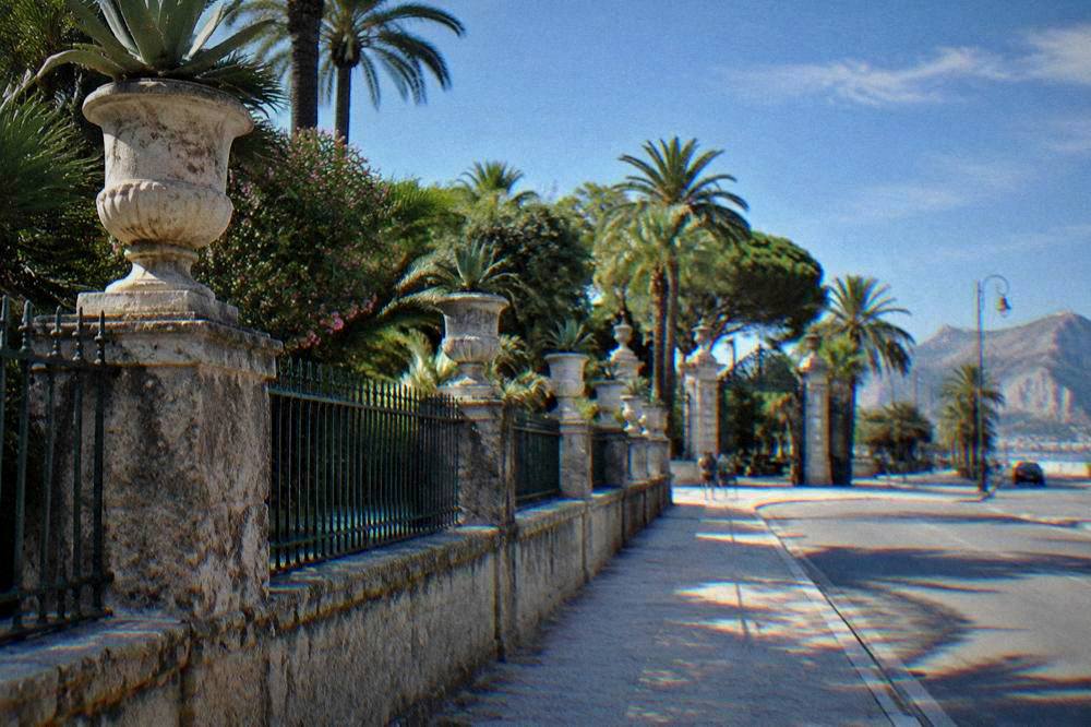 A view along the garden wall of Villa Giulia toward the street with the Botanical Garden entrance beyond