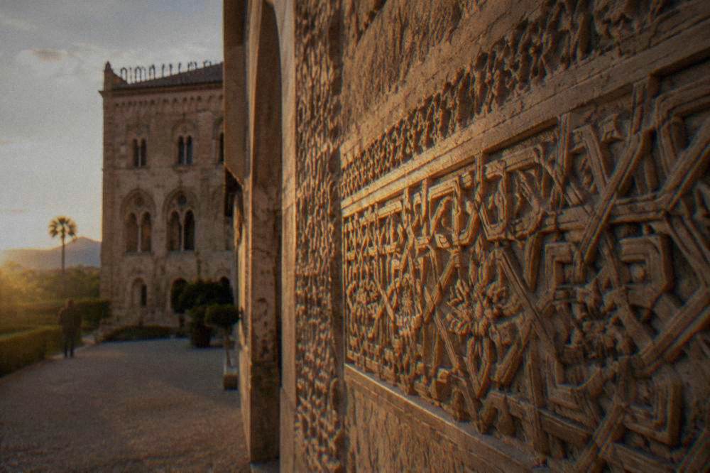 A detail of carved stucco decoration on a palace wall with geometric patterns