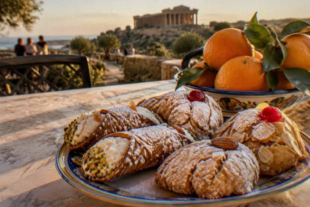 Sicilian almond pastries and fresh oranges on a restaurant table