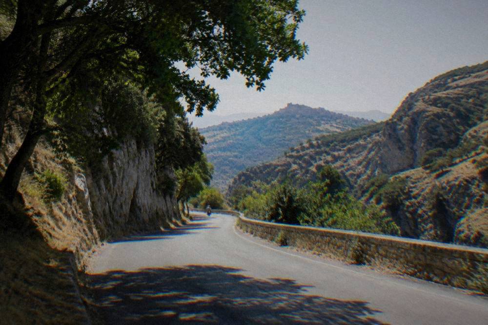 A countryside road winding through gorges and rocky hills in inland Sicily