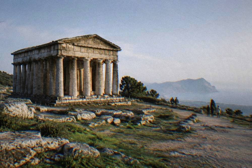 Doric temple standing in open countryside at an archaeological park in Sicily