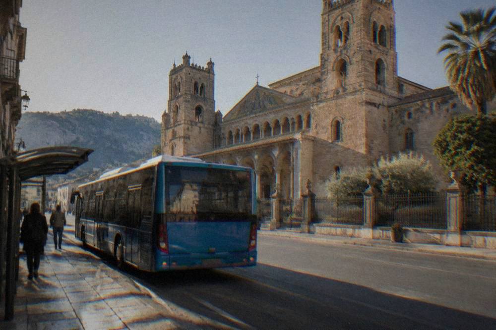 AMAT city bus at a stop on a Palermo street in morning light