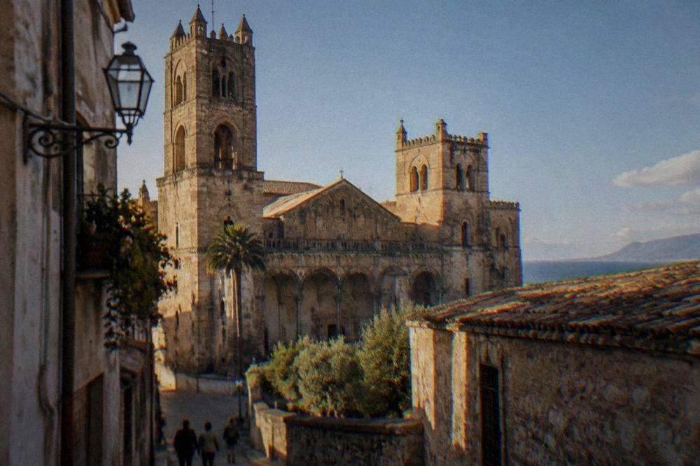 The cathedral exterior seen from a narrow street in Monreale