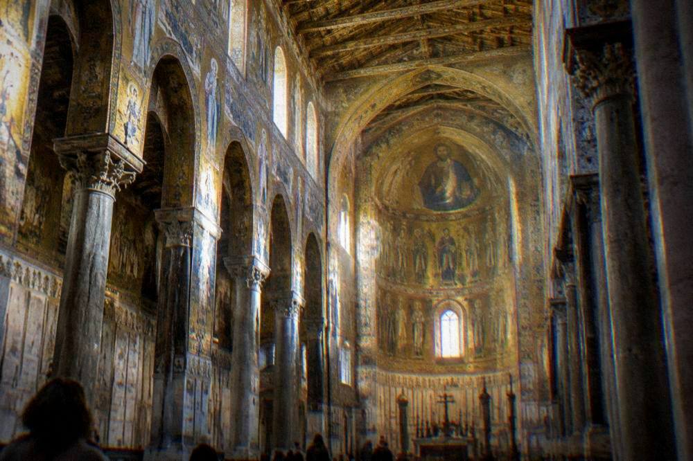 Sunlight falling across the mosaic vault of the Monreale Cathedral nave