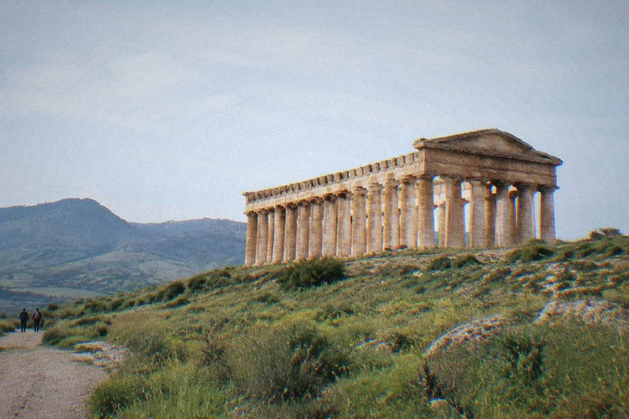 The unfinished Greek temple of Segesta standing on a hillside in western Sicily under a clear sky