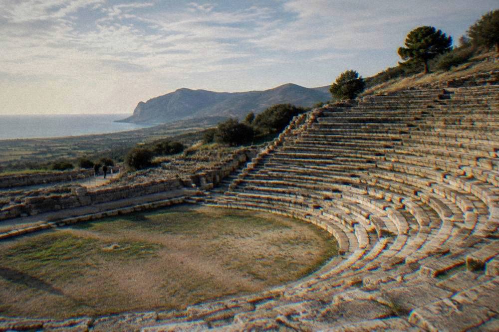 Stone tiers of an ancient theatre empty of visitors in late afternoon light
