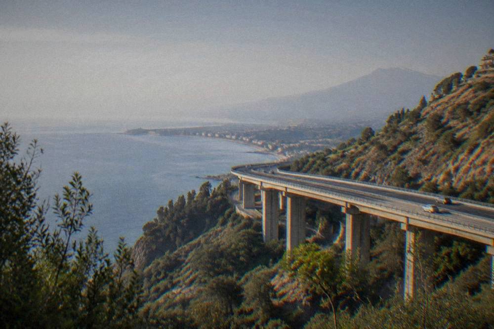 Coastal motorway viaduct crossing hilly Sicilian countryside near the east coast