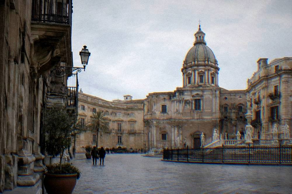 A quiet square in Palermo in winter with historic facades under a soft sky