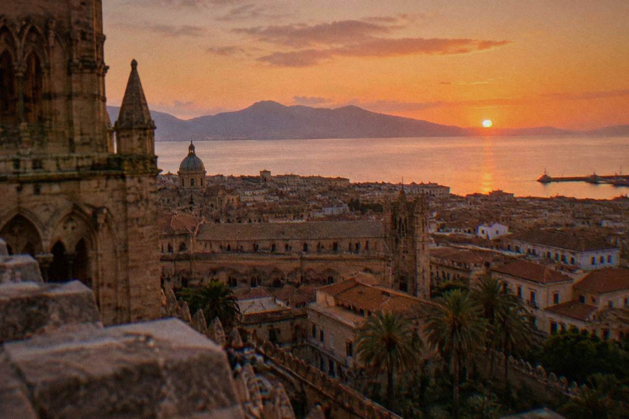 Palermo rooftops and the sea seen from the cathedral roof in evening light