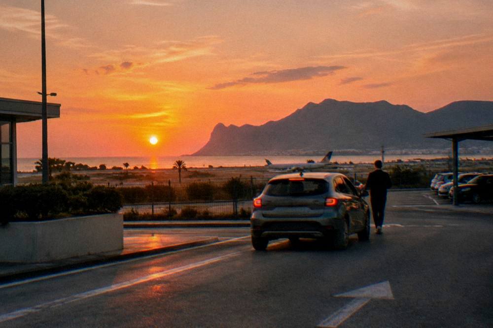 A hire car being returned to a parking bay at Palermo airport at sunset