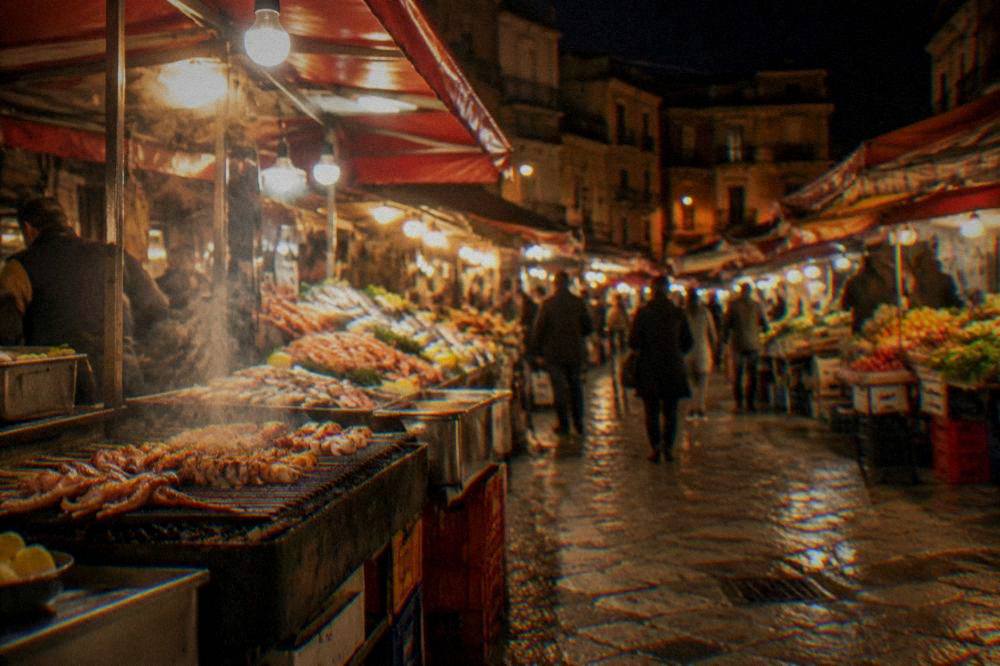 Street food stalls glowing under lights in a Palermo market at night