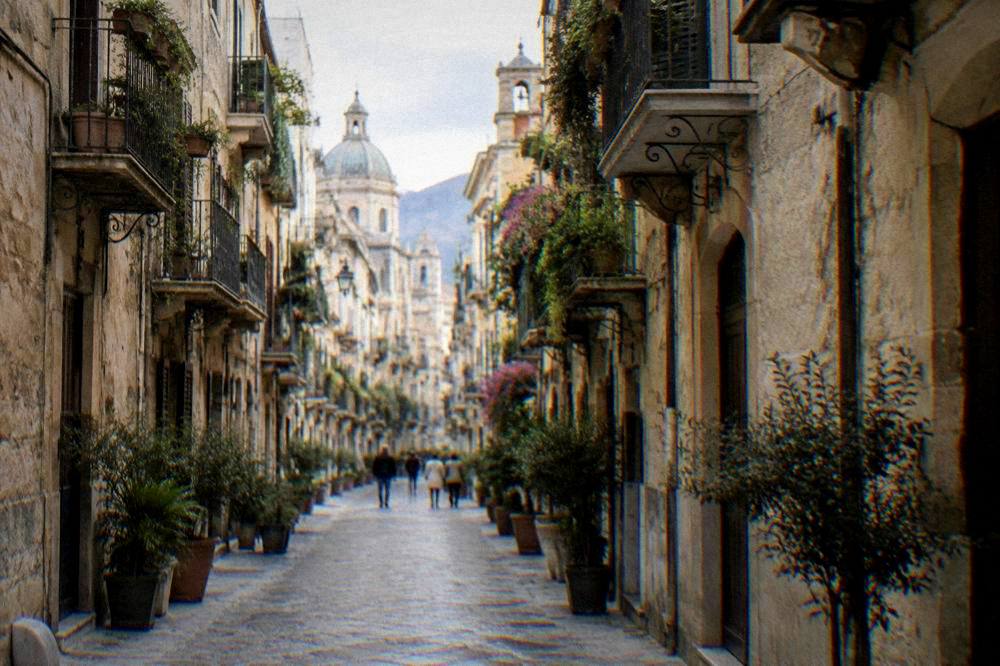 A narrow Palermo street closed to traffic with balconies on both sides