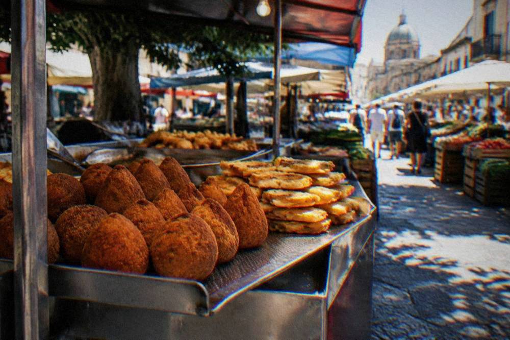 Fried food counter at a Palermo market with arancine and panelle