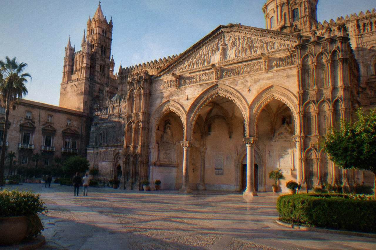 The decorated southern porch of Palermo Cathedral seen from the square in late afternoon light