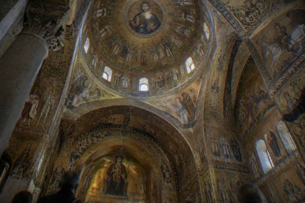 The gold mosaic interior of the Cappella Palatina in Palermo seen from below the dome