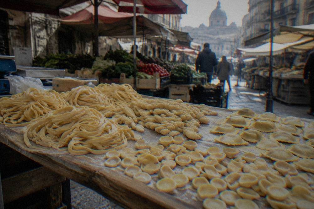 Fresh handmade pasta shapes laid out on a wooden board ready for cooking