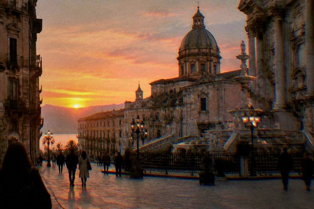 A Palermo square in early evening light with ornate baroque buildings, a fountain and people crossing