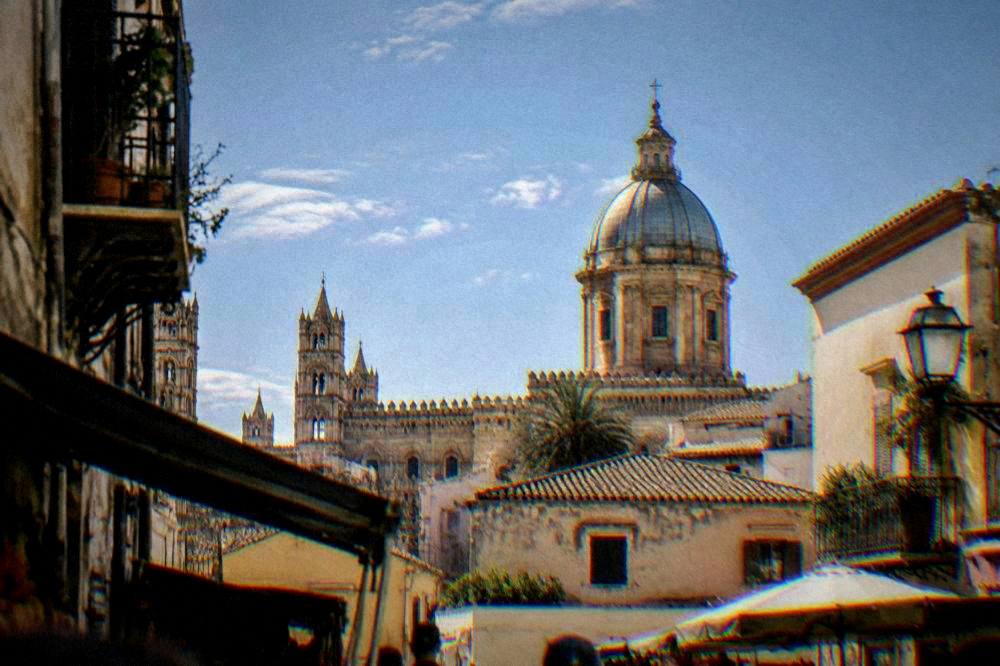 The dome of Palermo Cathedral seen above rooftops near the old market quarter