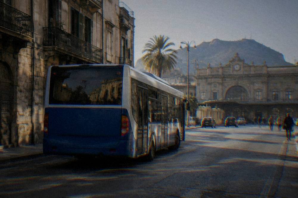 A city bus parked on a Palermo street near the central station