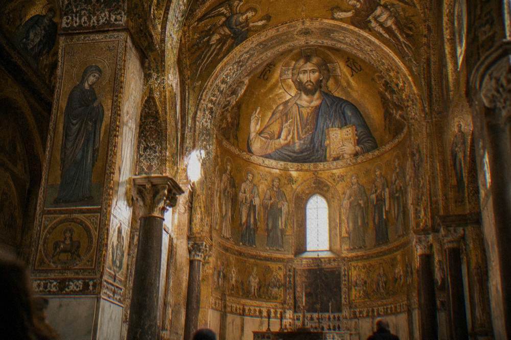 Interior of a ornate chapel with golden mosaics in Palermo